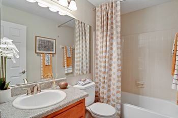The arbors at breckinridge apartment homes model bathroom with ceramic tile in tubs and showers